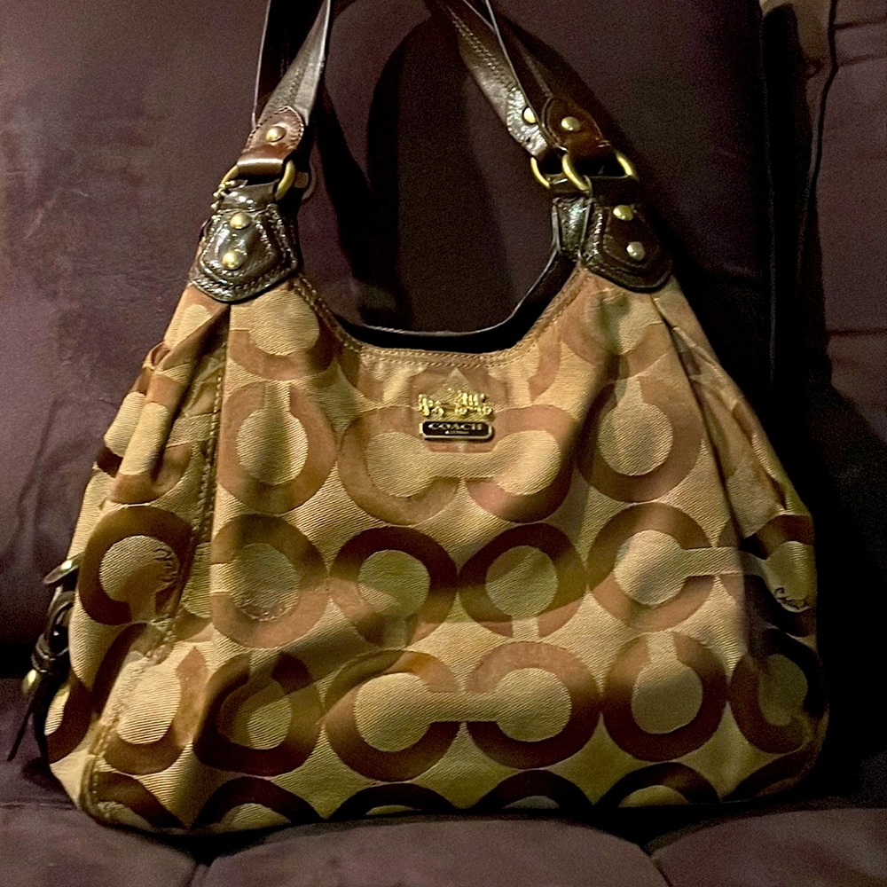 A coach bag that is brown and tan